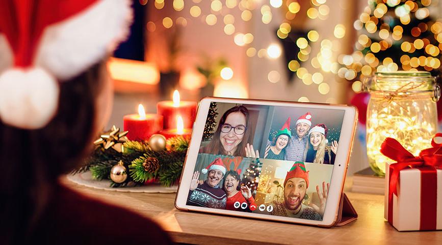 A person wearing a Santa hat in a Zoom gathering with other people