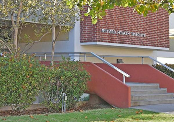 Exterior of a brick building with a sign "Student Health Center."