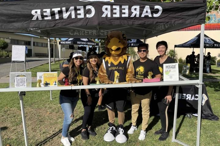 Career Center Staff smile with Eddie outside of the Career Center